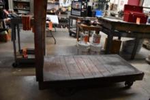 WOODEN FOUNDRY STYLE FLAT CART WITH 12" AND 6" CAST IRON WHEELS AND TWO HANDLES,