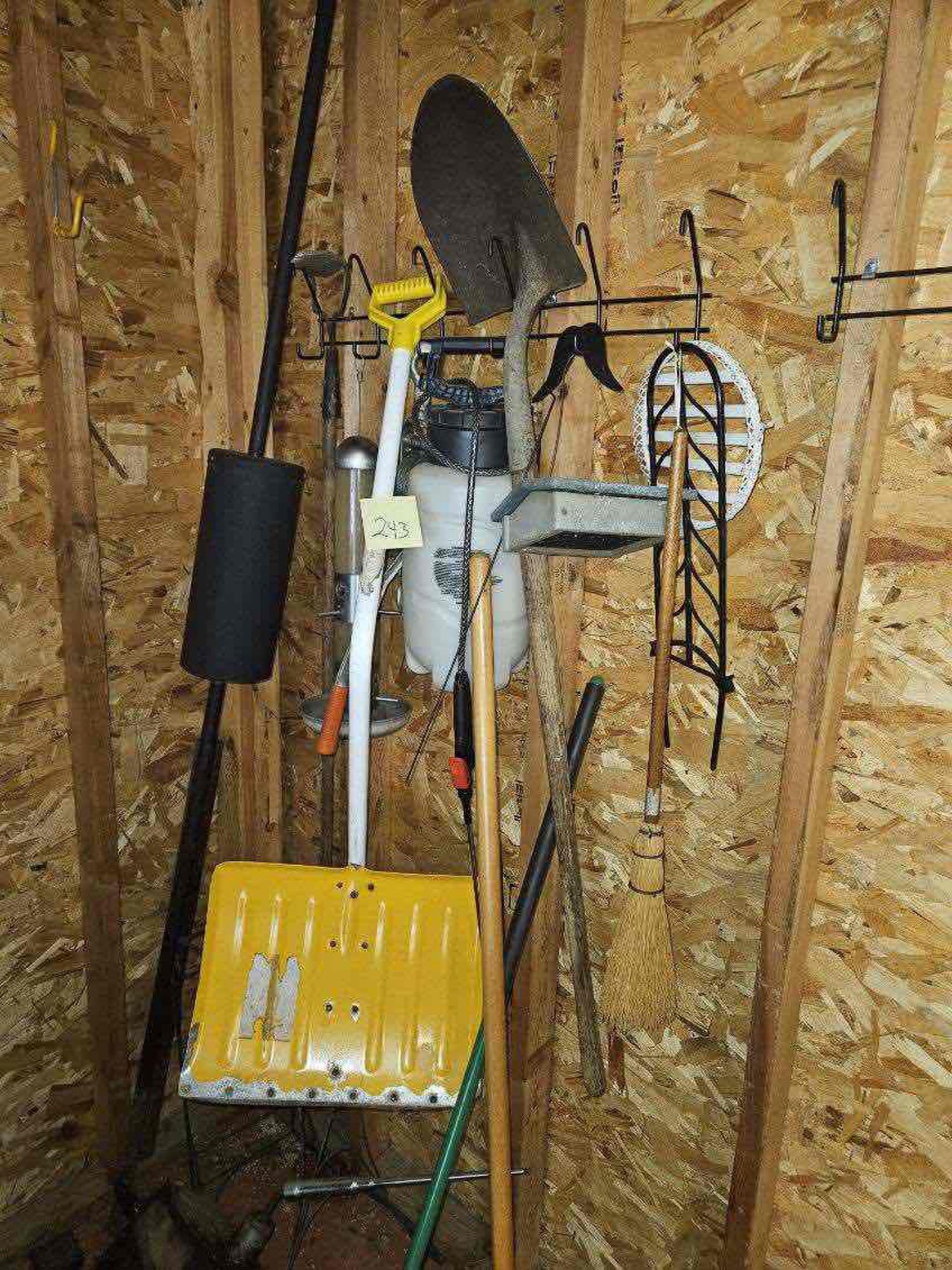 Corner of Garage yard tools, shepherd hook, fan, shovels