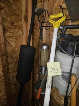 Corner of Garage yard tools, shepherd hook, fan, shovels