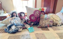 decorative pillows, dolls, and the cat