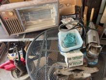 in house garage- table with sander, jars, edging, heater, and small Toro chainsaw
