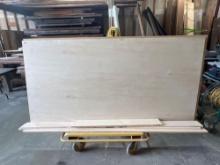 Drywall cart with pieces of wood and 4x8 in plywood