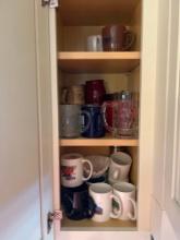 Cabinet's full of mugs, plates and glasses