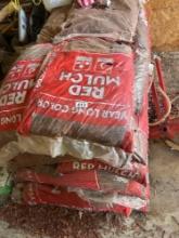 Several bags of red mulch