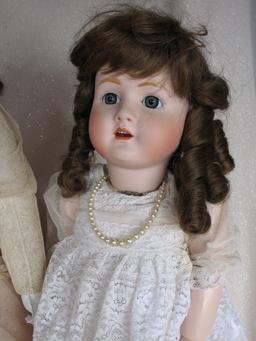 Four reproduction porcelain dolls:- Jumeau long face Bebe 43cm on compositi