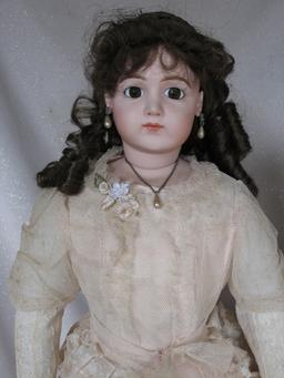 Four reproduction porcelain dolls:- Jumeau long face Bebe 43cm on compositi