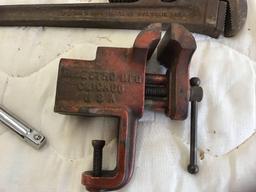 Stanley handsaw, wrecking bar, pipe wrench, vice, and half inch extension