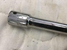 Stanley handsaw, wrecking bar, pipe wrench, vice, and half inch extension