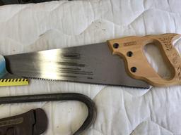 Stanley handsaw, wrecking bar, pipe wrench, vice, and half inch extension
