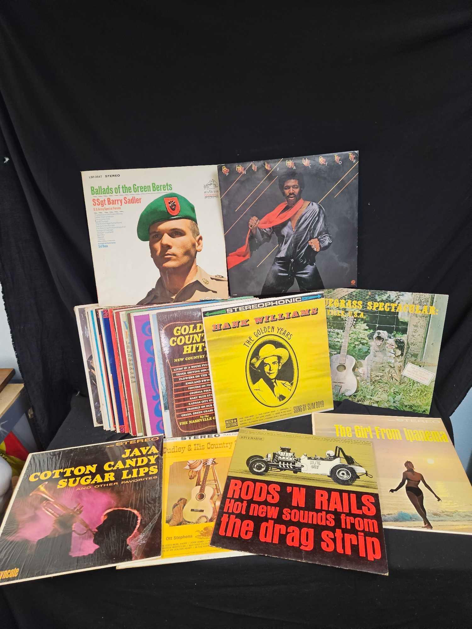 Vintage LP vinyls, including Hank Williams, the girl from ipanema, rods and rails drag strip sounds.