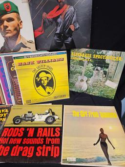 Vintage LP vinyls, including Hank Williams, the girl from ipanema, rods and rails drag strip sounds.