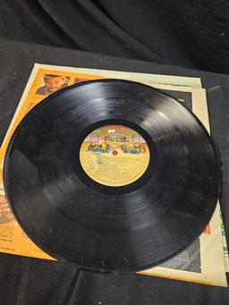 Vintage LP vinyls, including Hank Williams, the girl from ipanema, rods and rails drag strip sounds.