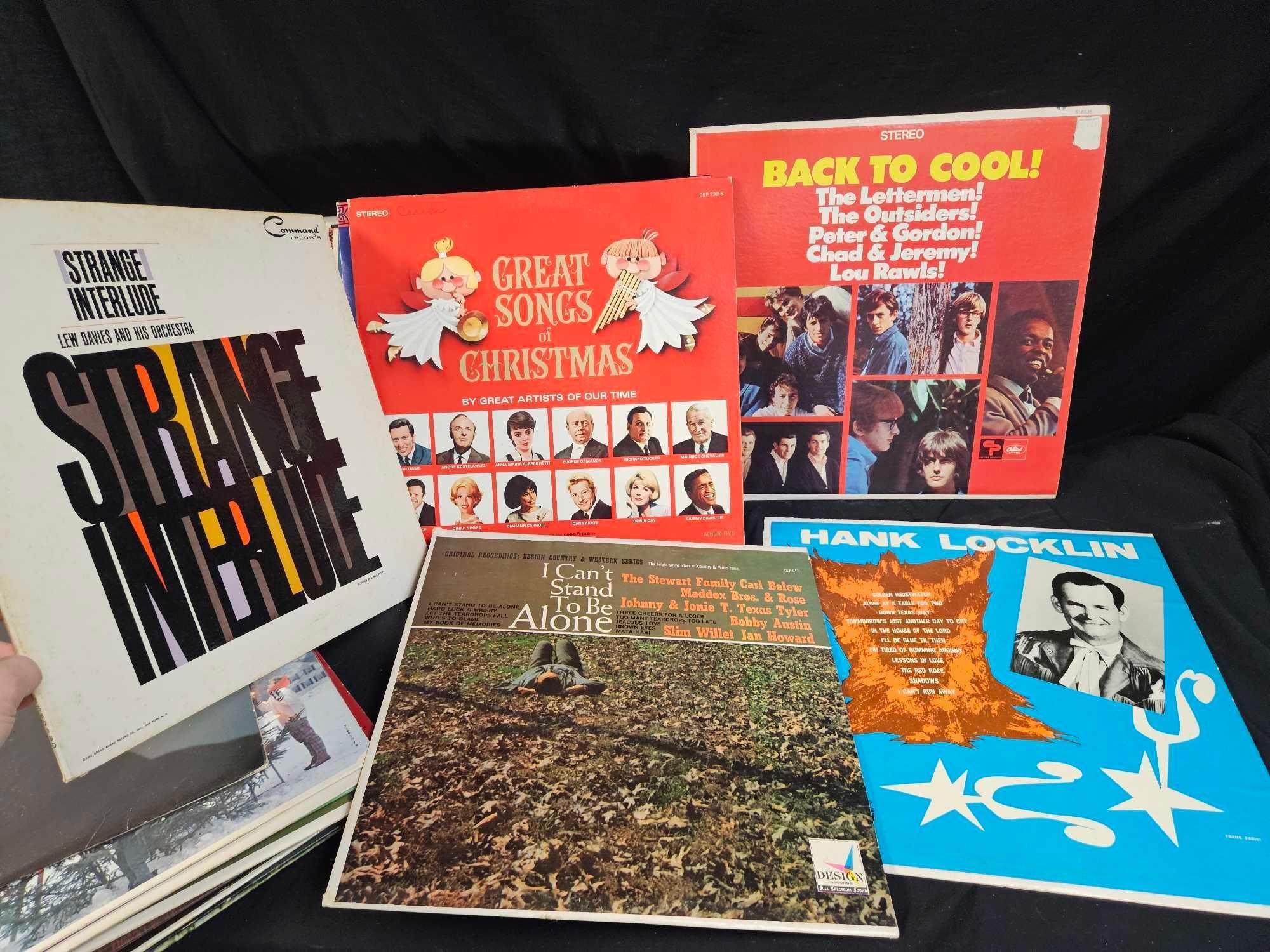 Vintage LP vinyls, including Hank Williams, the girl from ipanema, rods and rails drag strip sounds.