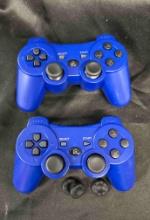 two blue DualShock 3 wireless controllers for the PlayStation 3 (PS3)