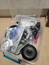 Tote contamier full of charger cords, earphones, more