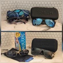 4 pairs of name brand sunglasses in cases