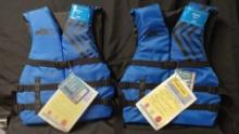 TWO UNIVERSAL ADULT LIFE VESTS, With tags