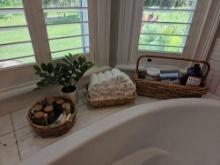 Basket of Bath decor and treats, including washcloths