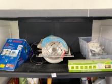 Contents of 1st shelf including makita saw Bosch laser and more
