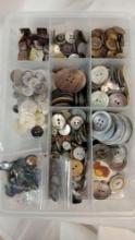 Vintage buttons, primarily appearing to be made from mother-of-pearl or similar shell materials in a