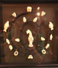 Frame of Eskimo Hand Carved Ivory Animals and Fishing Carvings