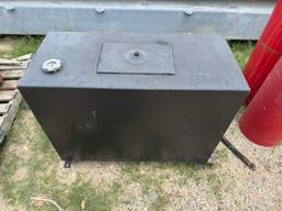 Hydraulic tank with mixed hoses and fittings.