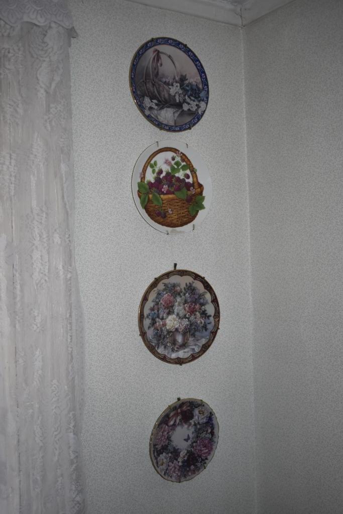 3 john deere plates, group of plates on sill, other plates, decorative wall hanger