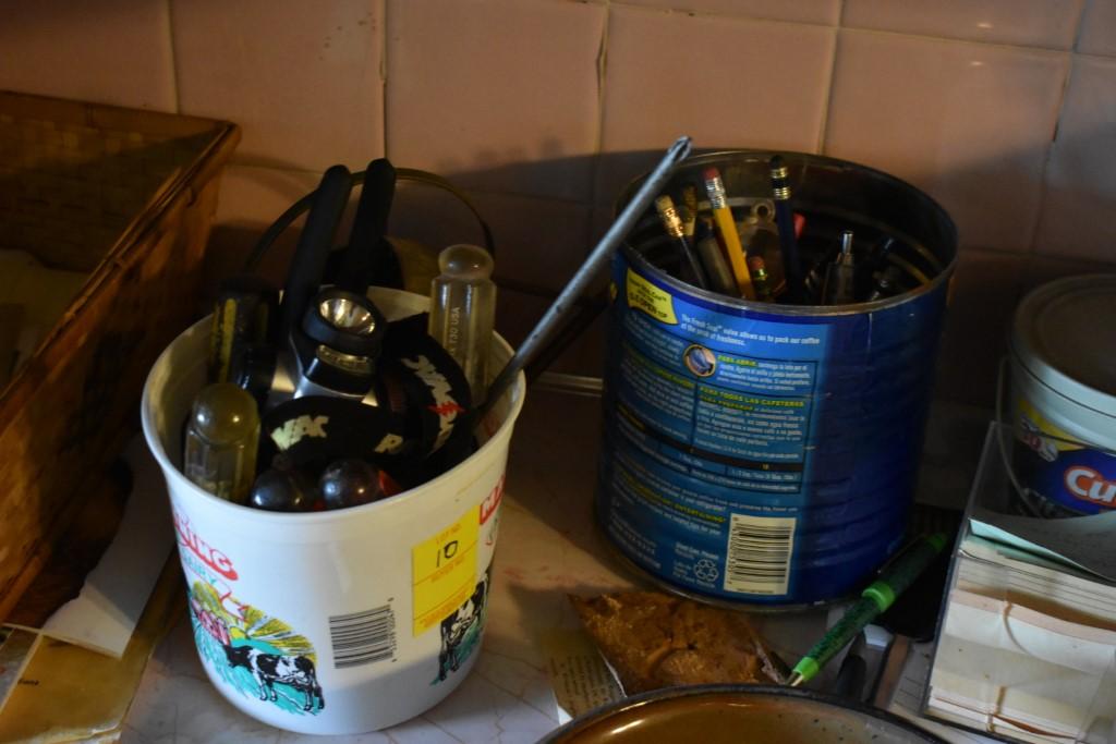 Contents Of counter including pens and headlamp a 2013 CS Amman Hand crafted pottery