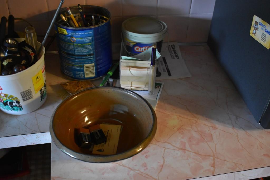 Contents Of counter including pens and headlamp a 2013 CS Amman Hand crafted pottery
