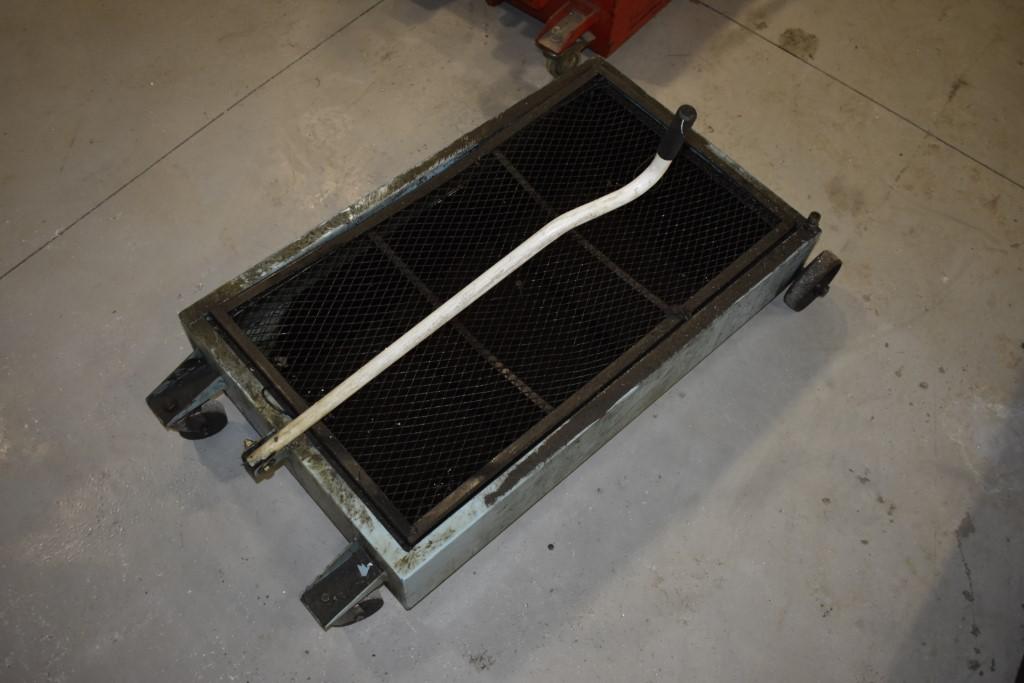 Under Truck Oil Pan on Wheels