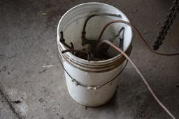 Bucket of Pipe Fittings and Some Copper Tubing