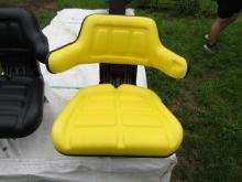 NEW YELLOW TRACTOR SEAT HAS TEAR IN ARM