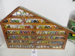 Large collection of John Deere marbles of all sizes in a barn display case