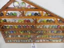 Large collection of John Deere marbles of all sizes in a barn display case