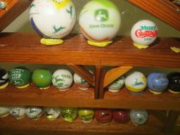 Large collection of John Deere marbles of all sizes in a barn display case