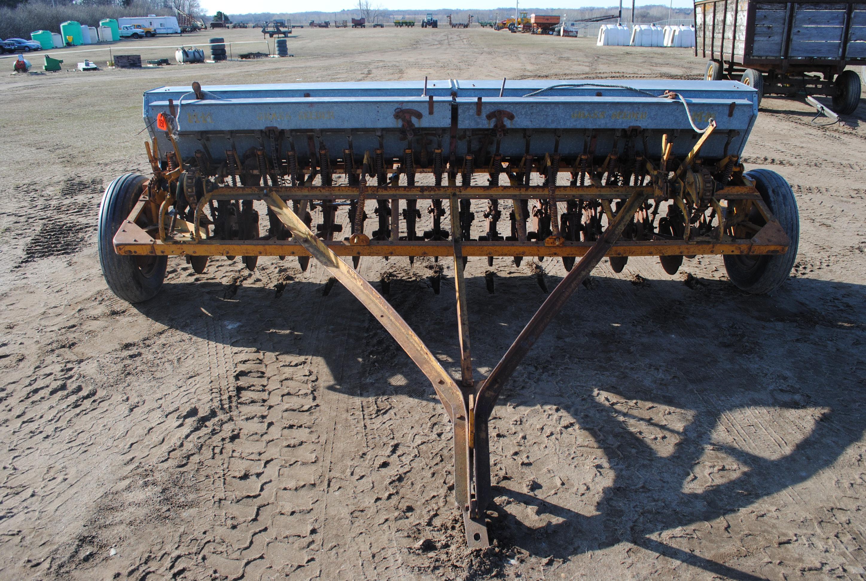 10' Minneapolis Moline grain drill with grass seeder on rubber, has a gear missing