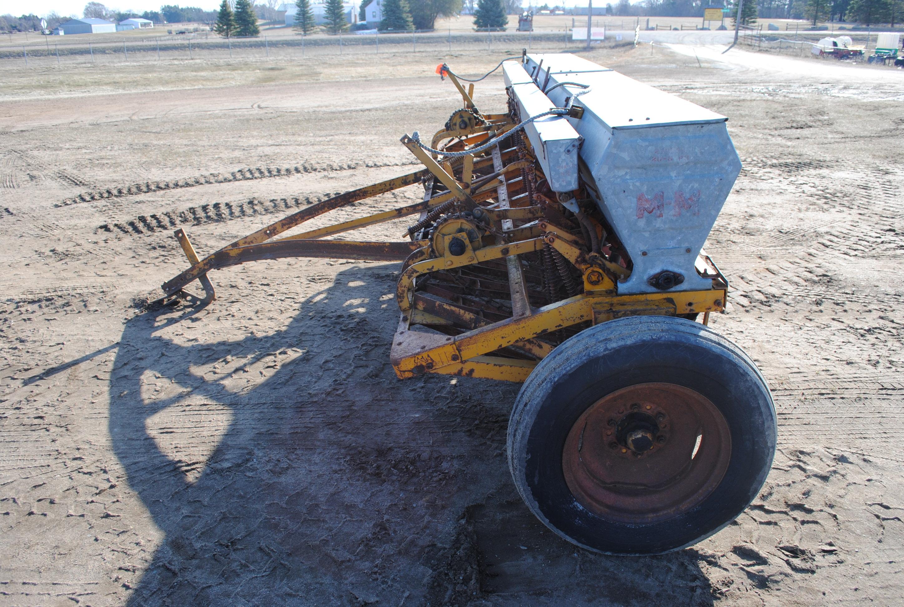 10' Minneapolis Moline grain drill with grass seeder on rubber, has a gear missing