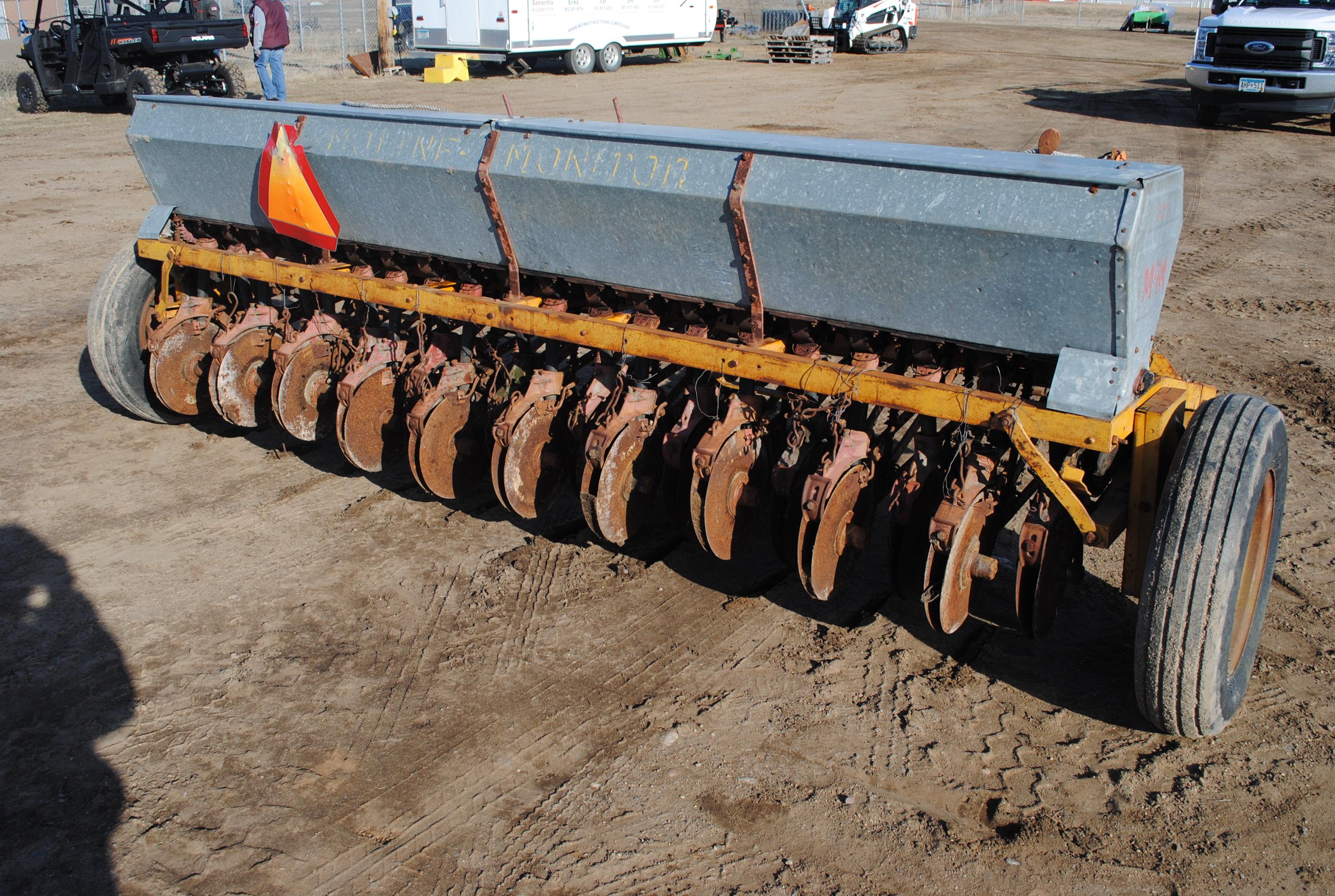 10' Minneapolis Moline grain drill with grass seeder on rubber, has a gear missing