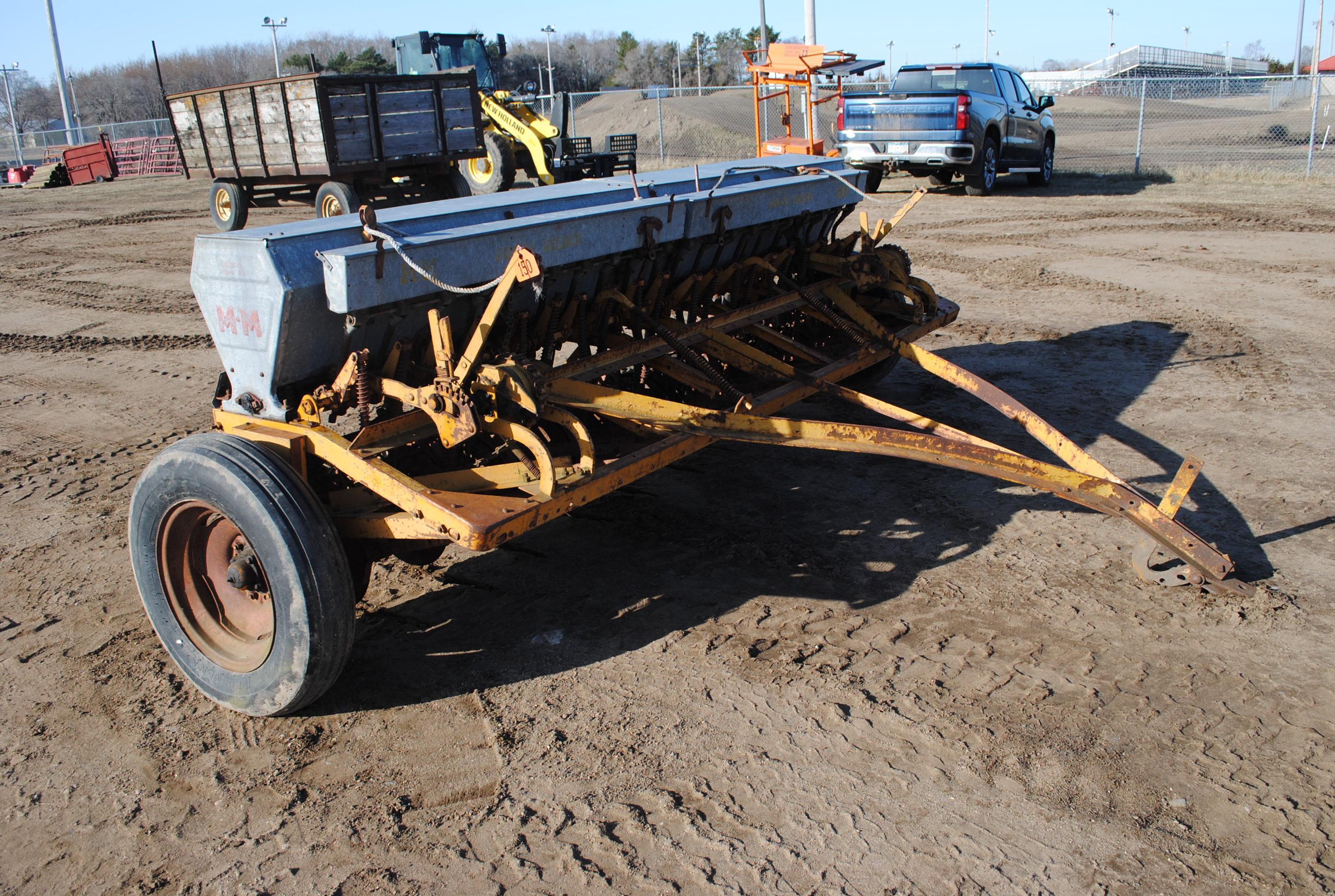 10' Minneapolis Moline grain drill with grass seeder on rubber, has a gear missing