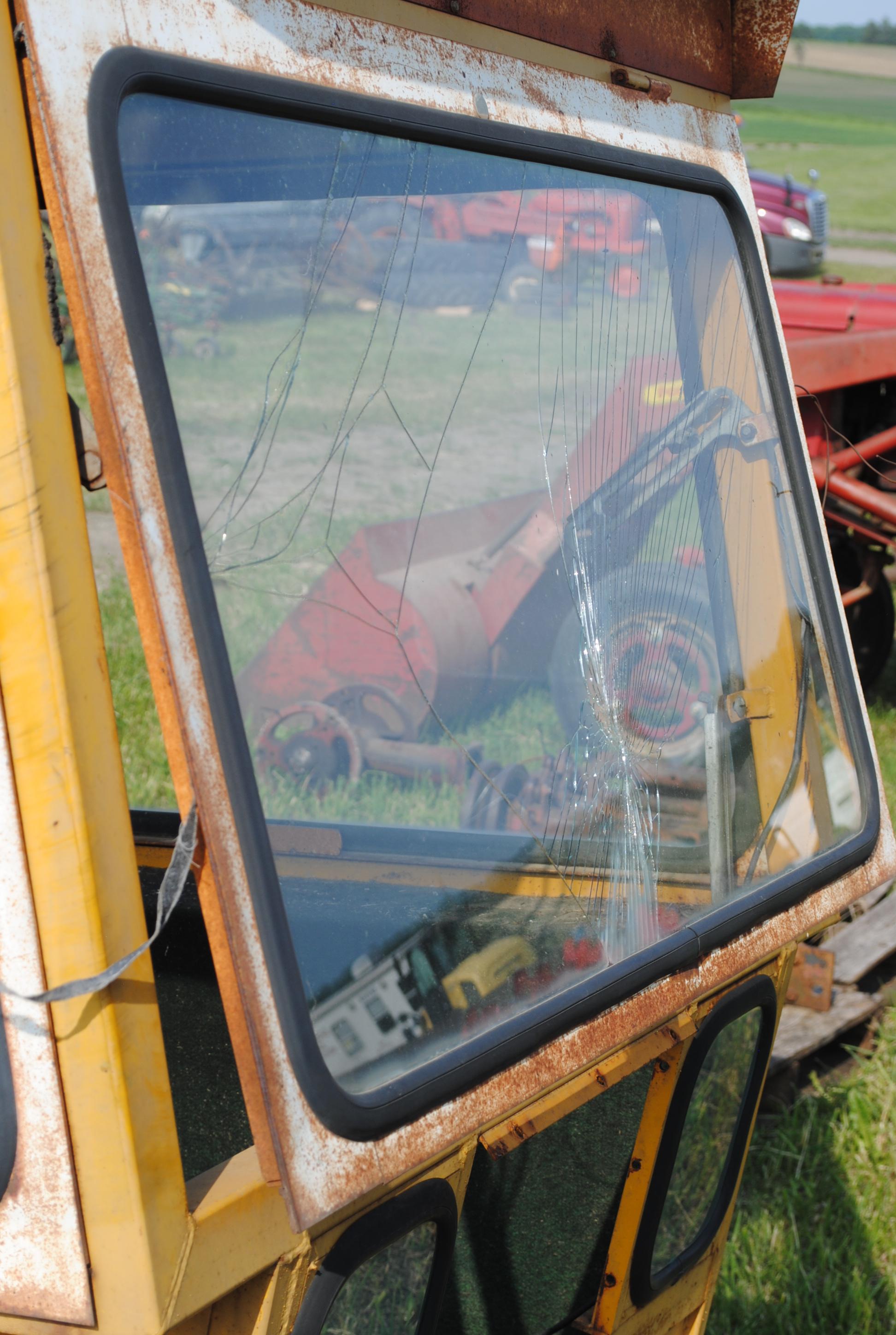 Tractor cab, broken back window