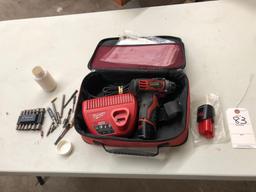 Milwaukee compact cordless driver with charger and nut driver accessories