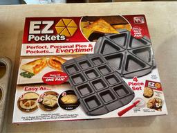 Rival crock pot, EZ Pockets 4 pc set, mixing bowls, muffins tin, baking pan, bundt pan.