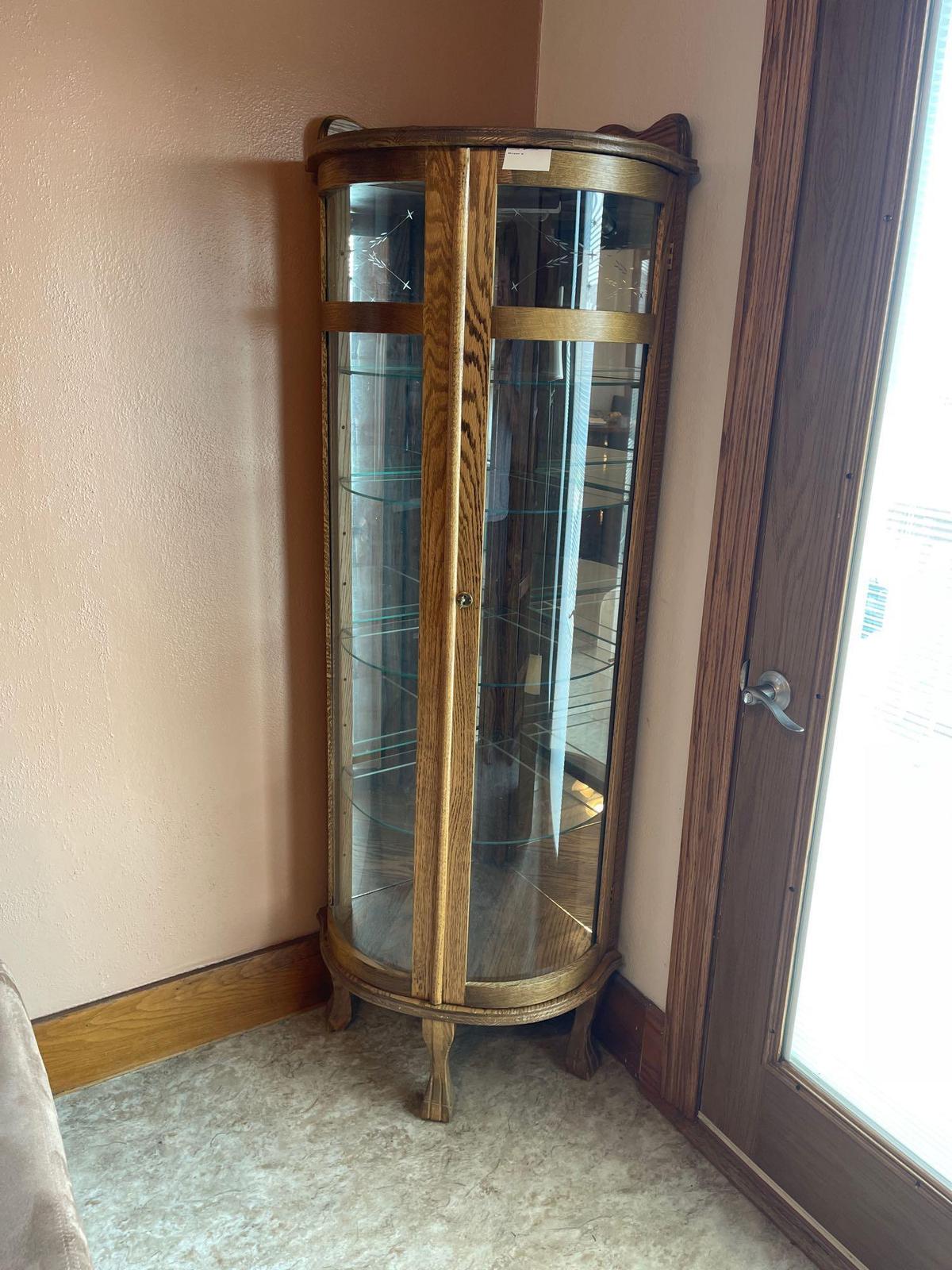 5 foot tall curve glass Curio cabinet with etched glass, five shelves , lighted (nice).
