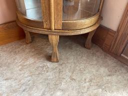 5 foot tall curve glass Curio cabinet with etched glass, five shelves , lighted (nice).