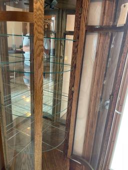 5 foot tall curve glass Curio cabinet with etched glass, five shelves , lighted (nice).