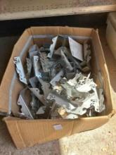 box of metal brackets, decorative sign