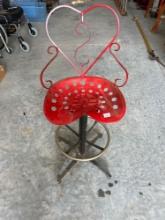 Homemade wrought iron bar stool with tractor seat.