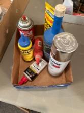Box of assorted paint, chalk, and aerosol cans