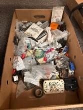 Box of assorted electrical parts, electrical tape, wire nuts, electrical switches, outlets