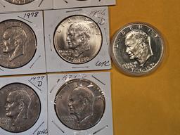 Thirteen mixed Eisenhower Dollars